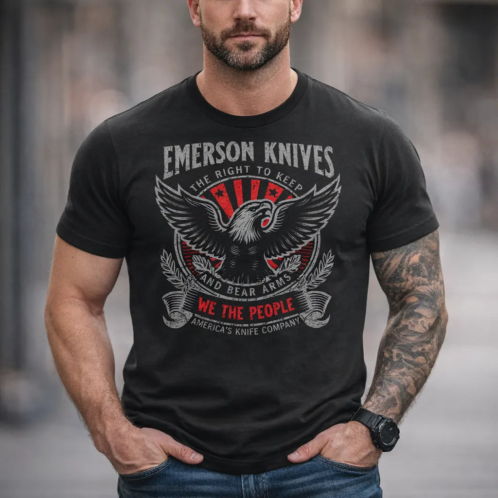 A man wears the We The People - Eagle T-Shirt by Emerson Knives, Inc., featuring an eagle, knives, and patriotic text—proudly supporting American values with America's Knife Company.