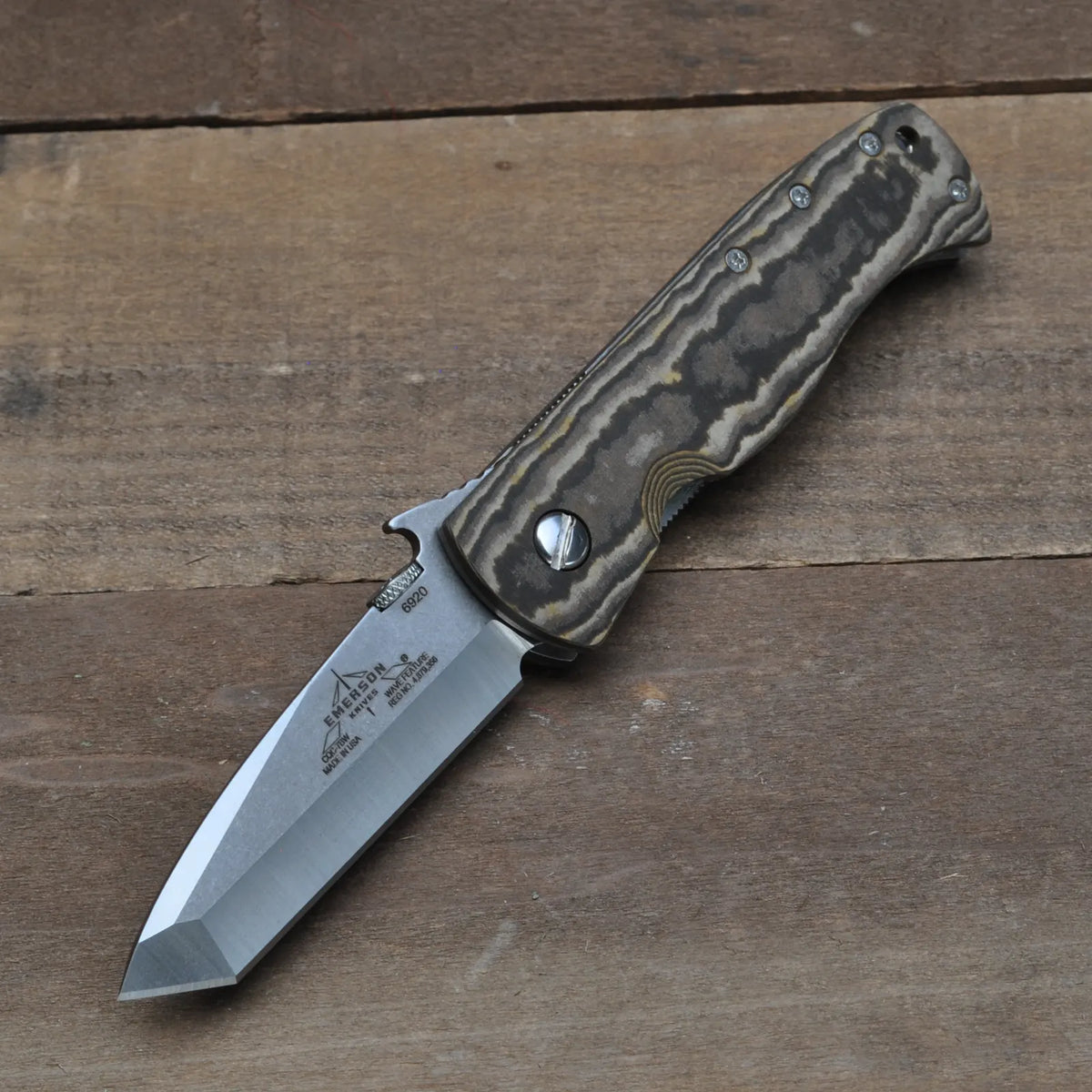 The Emerson Knives, Inc. CQC-7BW with Maple Richlite SF, a limited edition folding knife with a tanto-style blade and textured handle, features an engraved hinge—perfect for collectors.
