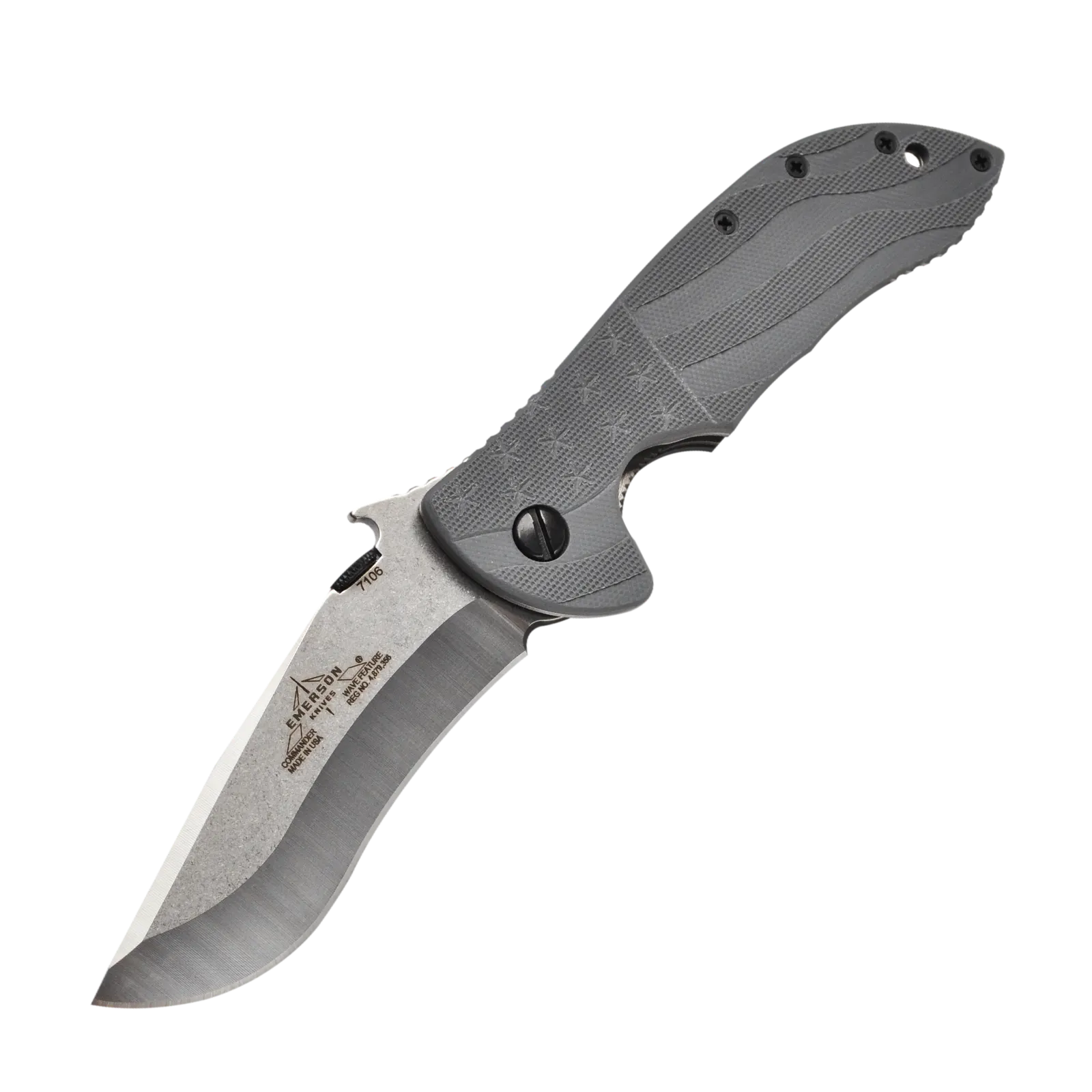 The Emerson Knives, Inc. Commander Flag is a folding knife with a textured tan handle, black screws, a thumb rest, and a partially serrated, curved silver blade featuring black markings.
