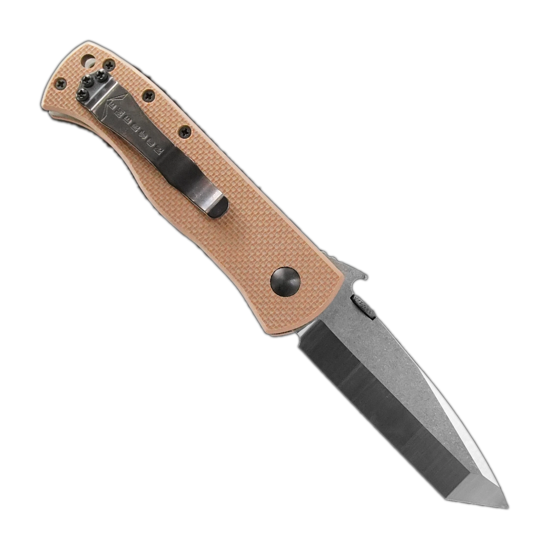 The Emerson Knives, Inc. CQC-7V is a folding pocket knife featuring a tan textured handle with black screws and a silver tanto-style blade engraved with text, displayed against a white background.