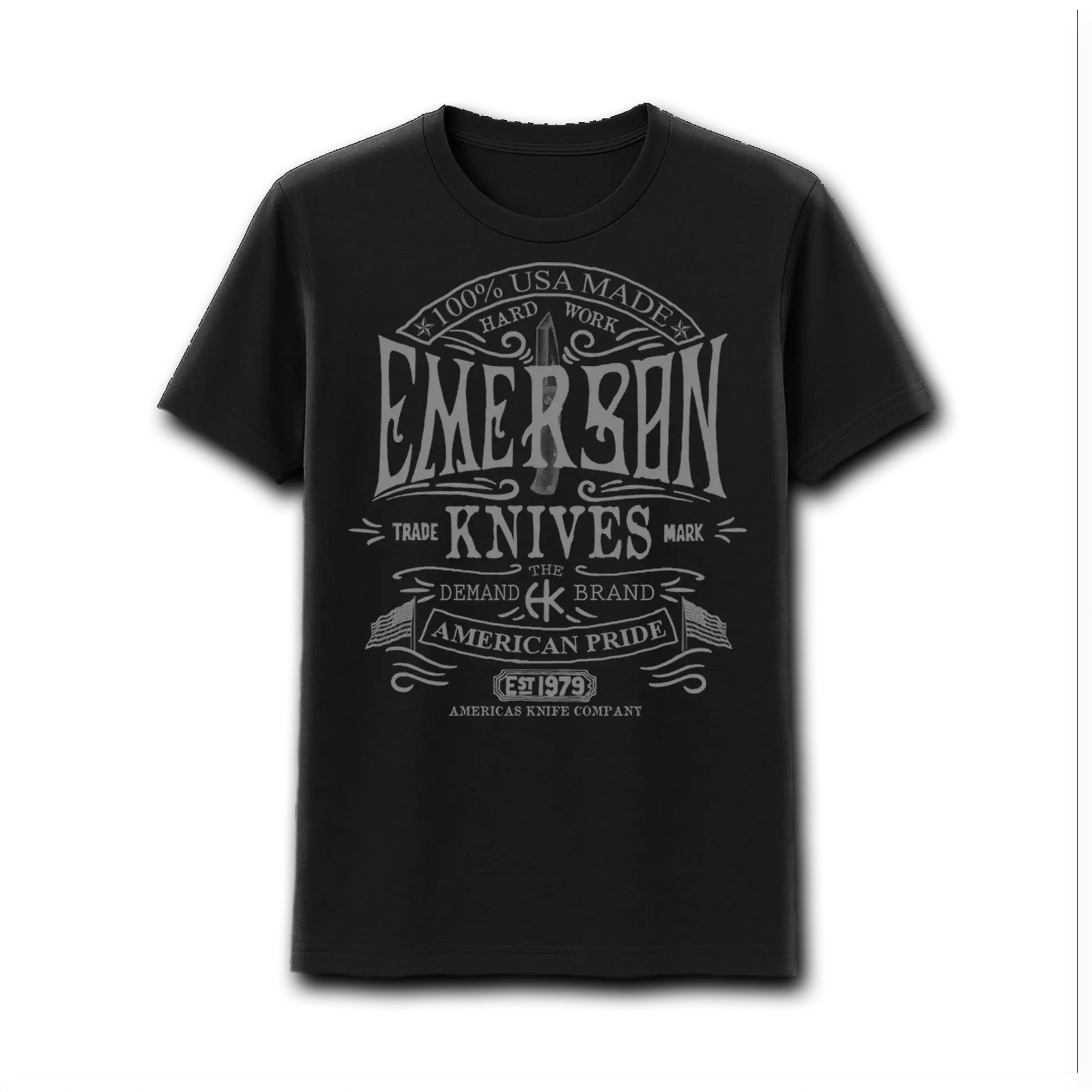 A man wearing an Emerson Knives, Inc. American Pride T-shirt with a backpack and hiking poles stands outdoors, mountains and trees in the background.