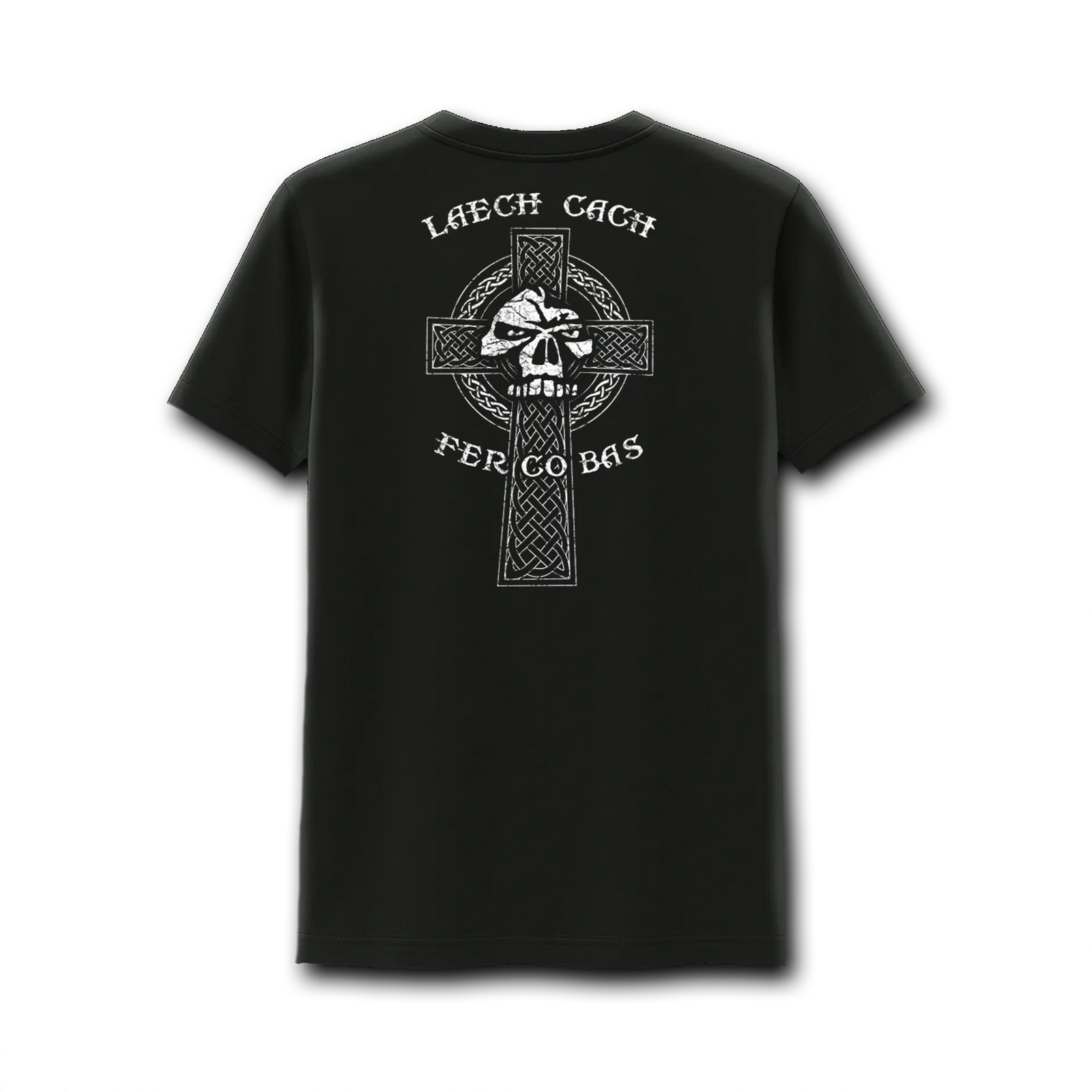 A man with a trimmed beard and tattooed right arm stands in a grassy park wearing the Emerson Knives, Inc. Celtic Warrior T-Shirt, featuring a small white emblem and text on the left chest. Trees and sunlight are in the background.